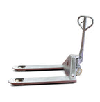 A metallic hand pallet jack with a wheel at the front and two flat forks, designed for lifting and moving heavy loads.