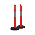 Two red traffic bollards with gray bands on a black hexagonal base, used for directing traffic or marking boundaries.