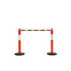 Two red and white traffic barriers with a black and yellow striped tape overhead, preventing passage in a clear space.