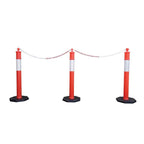 Three red and white traffic bollards connected by a chain, set on black octagonal bases, used for crowd control or road blocking.