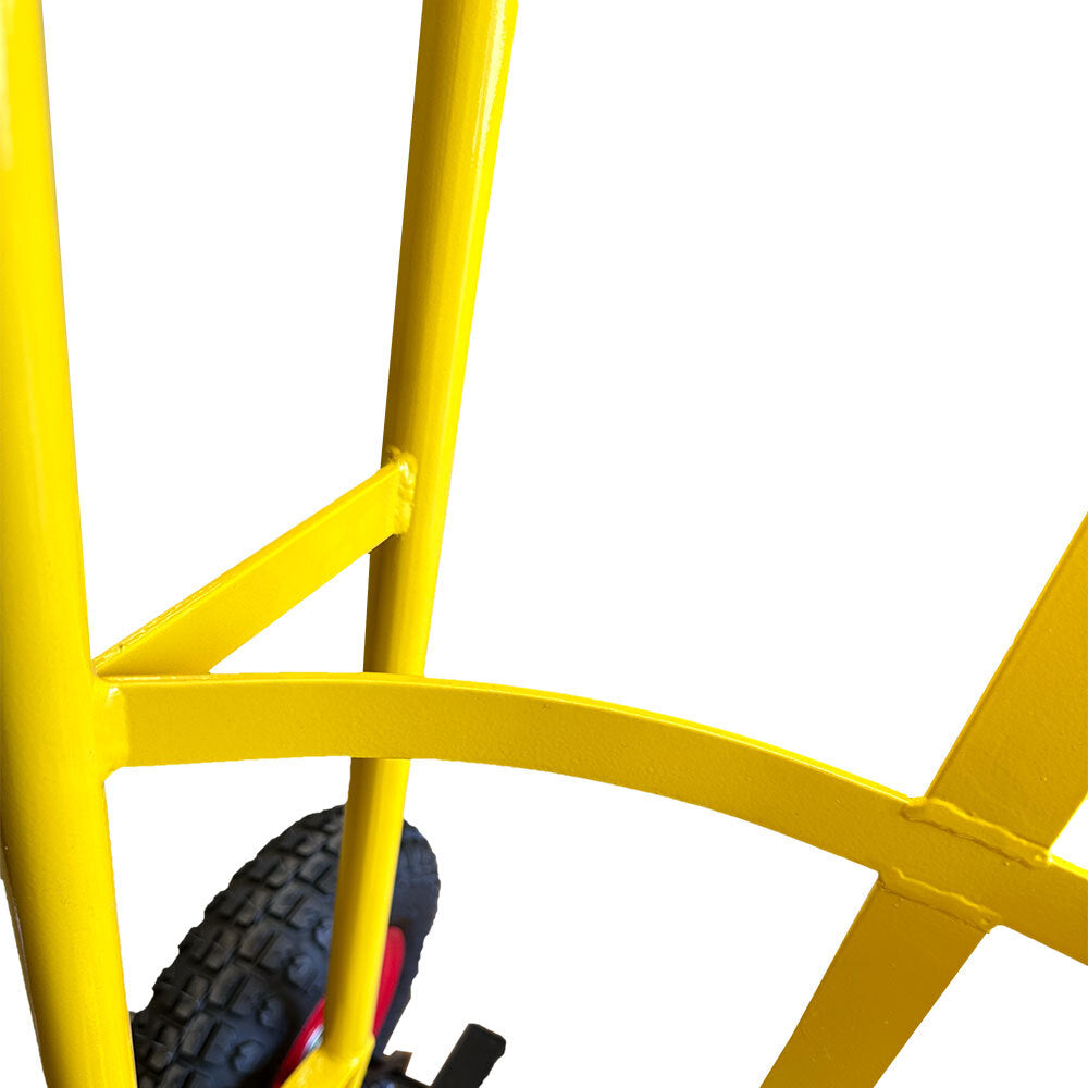 Close-up of a yellow hand truck's frame, showcasing the steel structure and wheel assembly on a white background.