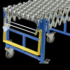 Blue flexible roller conveyor with metal rollers, yellow safety bar, and swivel casters for mobility and adjustable shape.