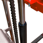 Close-up of a metallic chain alongside a shiny cylindrical rod and a black base, part of a mechanical device or equipment.