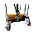Close-up view of hydraulic lift mechanism with metal supports, springs, and rotating red caster wheels, featuring a yellow base.