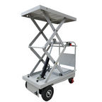Scissor lift table with a raised platform, hydraulic mechanism, and wheels for mobility, ideal for lifting heavy loads in various settings.