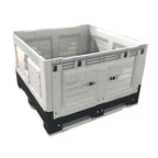A large, stackable plastic storage crate with vented sides, featuring a black base and white frame, ideal for transporting goods.