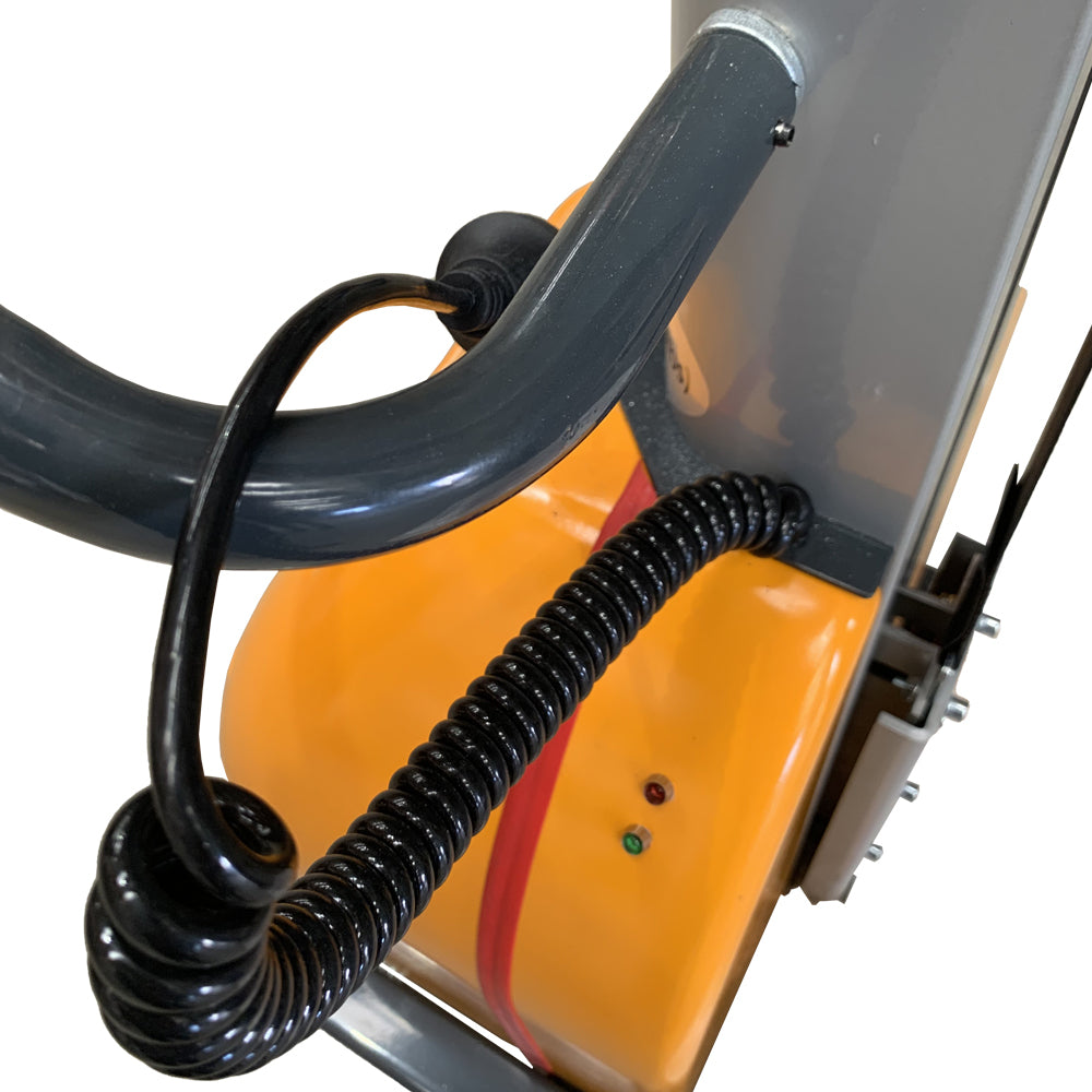 Close-up of a machinery control panel with black wires and an orange base, featuring indicator lights and a curved handle.