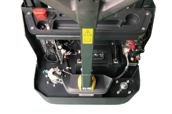 Top view of an electric stackers control panel, featuring wires, buttons, and safety labels in a compact design.