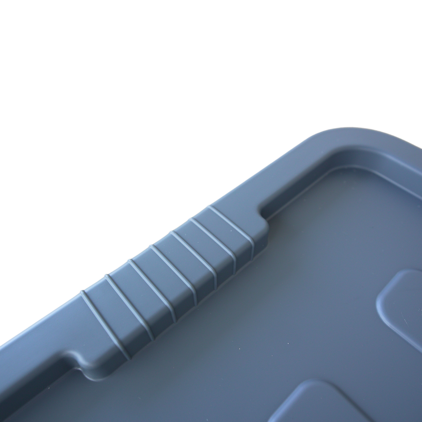 Close up of a grey storage container ribbed lid design where the handle grip is located.