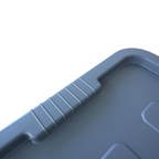 Close up of a grey storage container ribbed lid design where the handle grip is located.