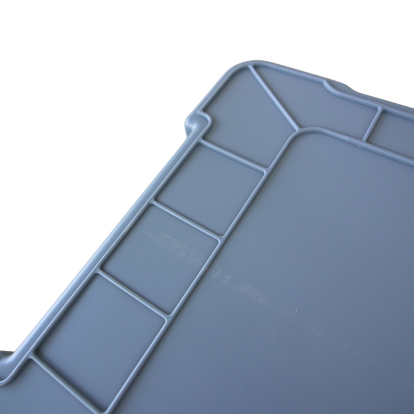 Close up of a grey storage container upside down showcasing the ribbed grip underneath.