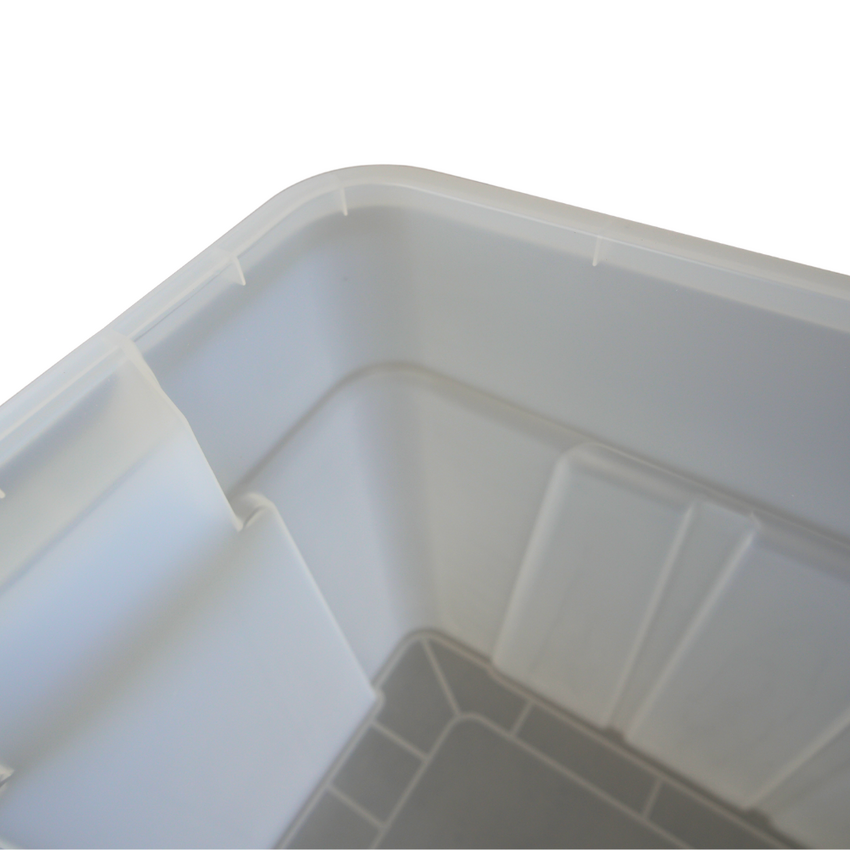 Close-up of a clear plastic storage container, showcasing its smooth corners and bottom design with grid patterns.