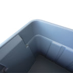 Close-up view of the interior of a smooth, grey plastic storage bin with angled sides and a clean, empty base.
