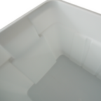 Close-up view of the interior of a smooth, white plastic storage bin with angled sides and a clean, empty base.