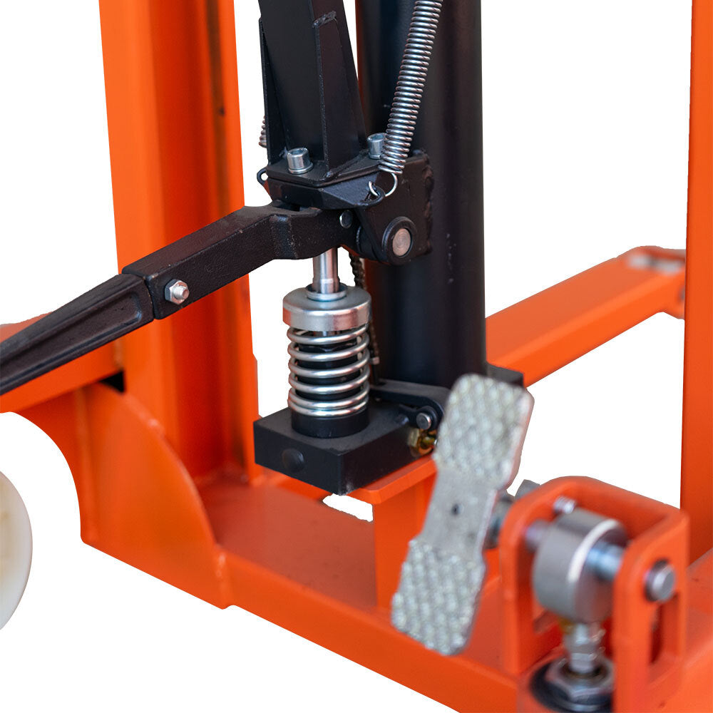 Close-up of a hydraulic lift's mechanical components, featuring a spring, lever, and foot pedal against an orange frame.