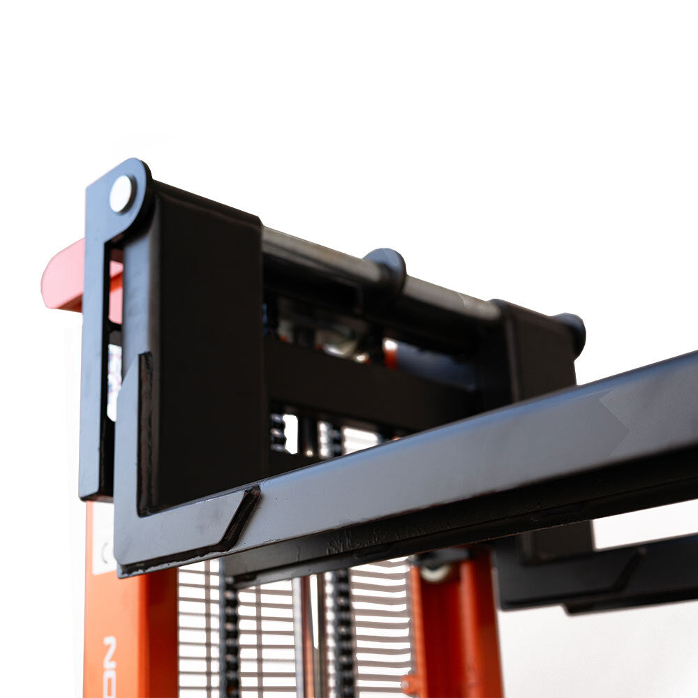 Close-up of a heavy-duty fork attachment on a forklift, showcasing its robust structure and mechanical components against a white background.