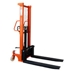Orange manual stacker with a vertical mast and two long black forks, designed for lifting and moving pallets easily.