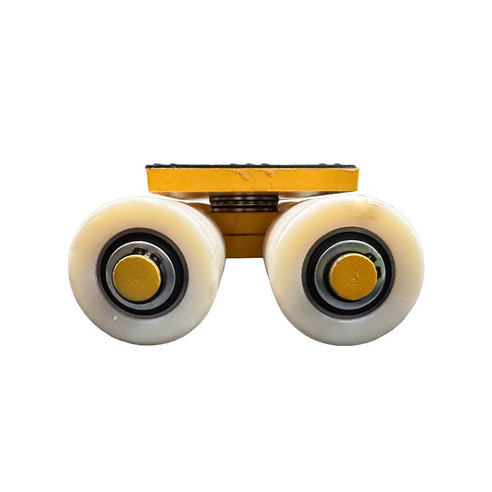 Close-up of a double roller skate axle with white wheels, featuring yellow and black components, viewed from the front.