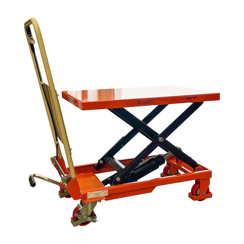 A red hydraulic lift table with a flat surface, black scissor mechanism, and wheels for mobility, ideal for lifting heavy objects.