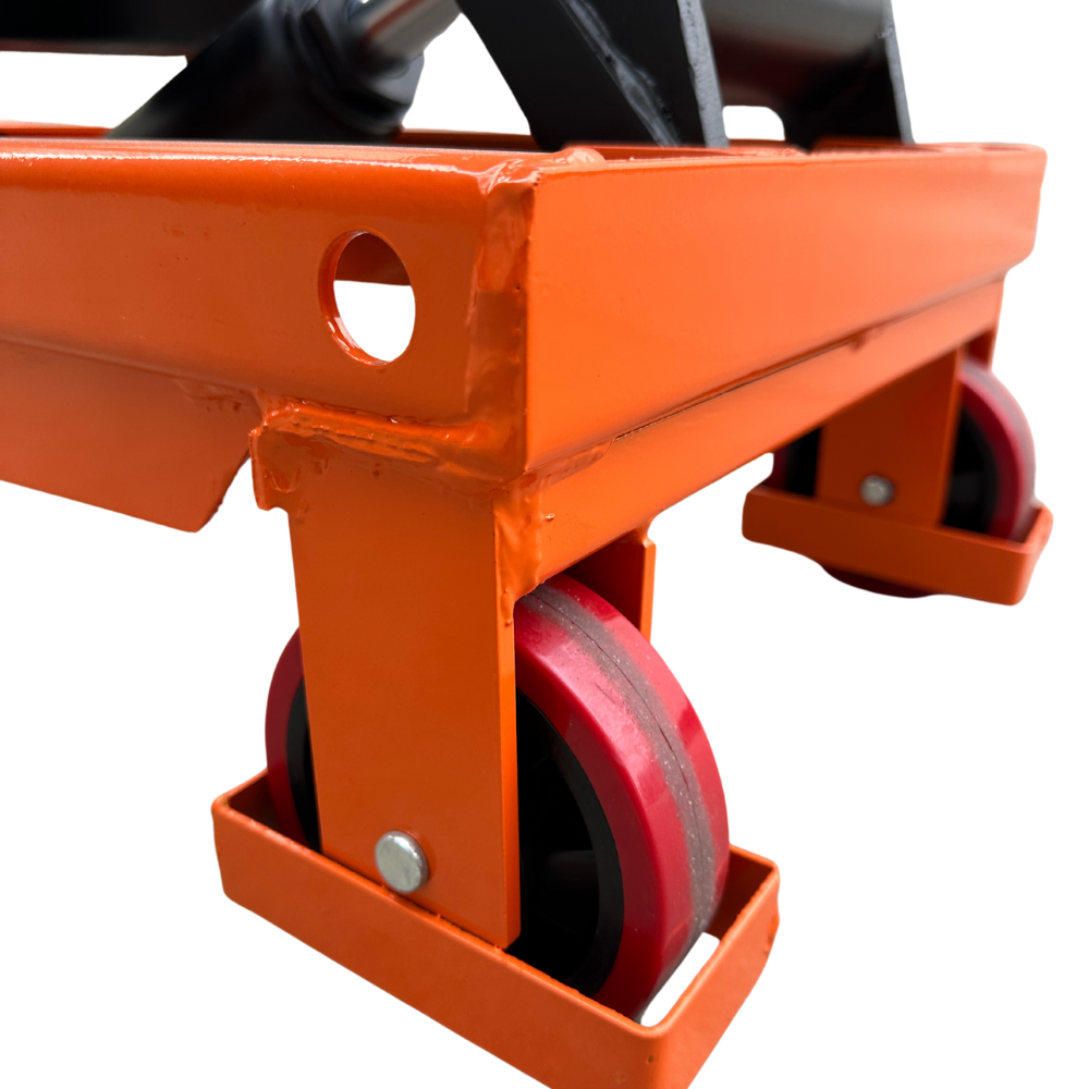 Close-up of an orange equipment cart with red rubber wheels, showing reinforced corners and a circular cutout for functionality.