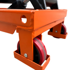 Close-up of an orange equipment cart with red rubber wheels, showing reinforced corners and a circular cutout for functionality.